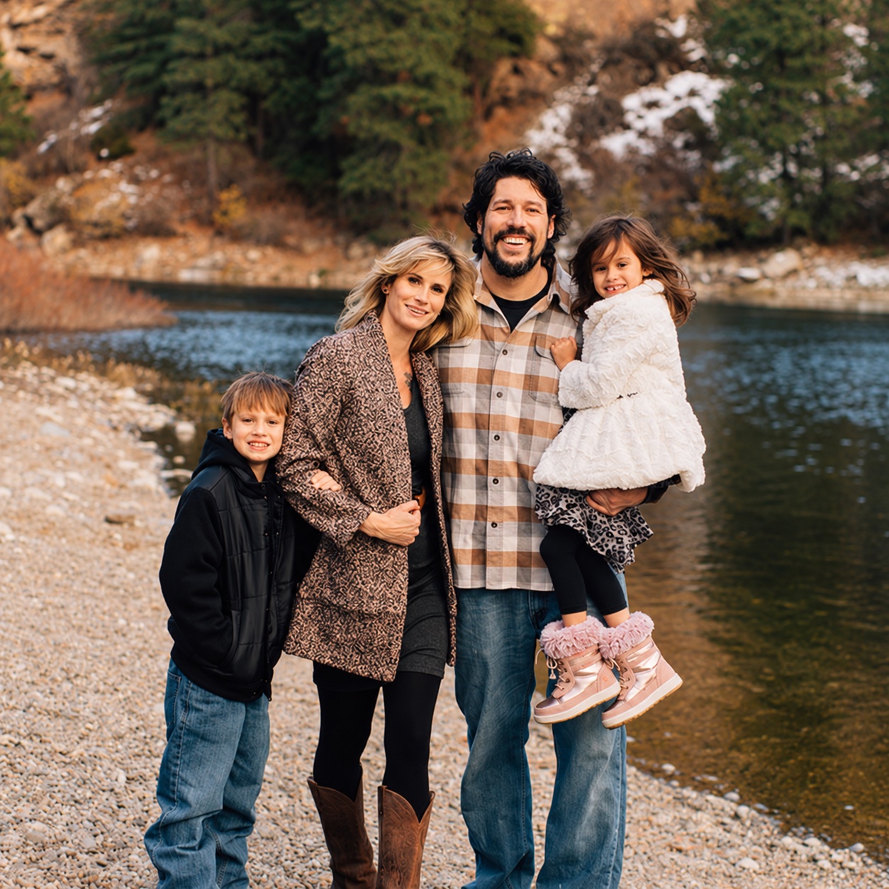 Will, Lynda, Otto and Opal together beside the water and evergreen trees
