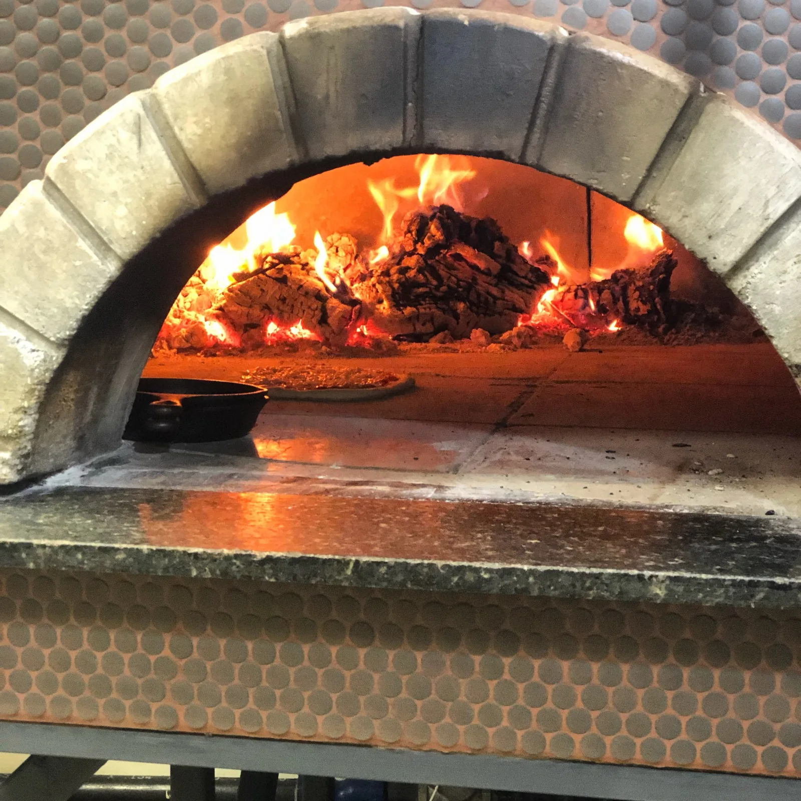 Fire burning in the Roots wood-fired oven