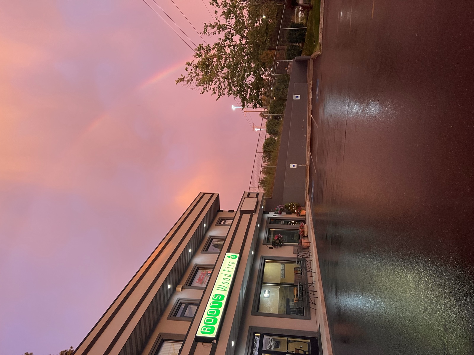 Roots Wood Fire on Northwest Boulevard beneath a pink sky and rainbow